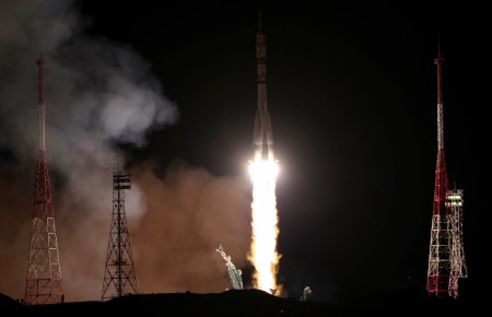 Spacecraft carrying Russians and American docks with International Space Station