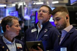 Traders work on the floor of the NYSE in New