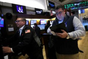FILE PHOTO: Traders work on the floor of the NYSE